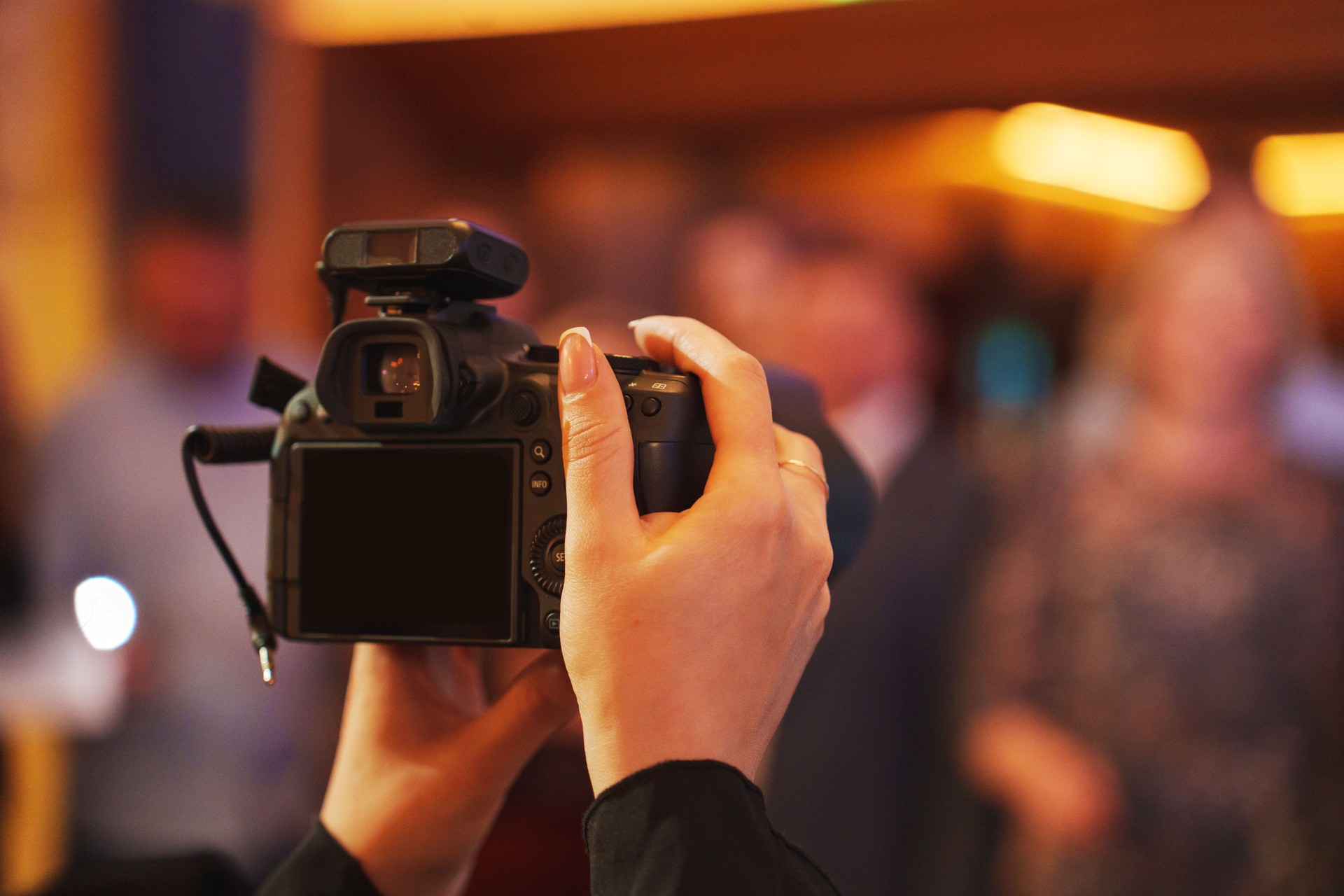 Capturing moments with a camera at a festive indoor gathering